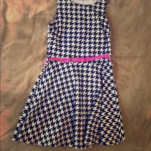 Black and white dress with pink belt.